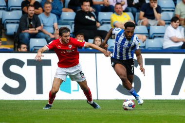 Liam Kitching #5 of Barnsley and Mallik Wilks #7 of Sheffield Wednesday during the Sky Bet League 1 match Sheffield Wednesday vs Barnsley at Hillsborough, Sheffield, United Kingdom, 3rd September 202