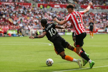 Crysencio Summerville #10 of Leeds United goes down under a challenge from Aaron Hickey #2 of Brentford during the Premier League match Brentford vs Leeds United at Brentford Community Stadium, London, United Kingdom, 3rd September 202