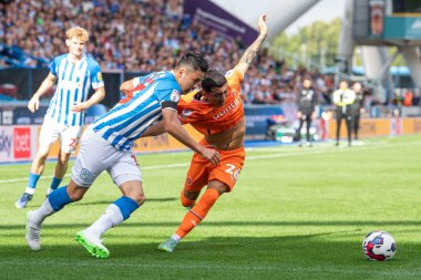 Ian Poveda #26 of Blackpool and Yuta Nakayama #33 of Huddersfield Town battle for the ball during the Sky Bet Championship match Huddersfield Town vs Blackpool at John Smith's Stadium, Huddersfield, United Kingdom, 4th September 202