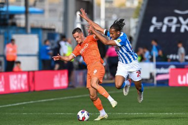 Jerry Yates #9 of Blackpool holds off Etienne Camara #24 of Huddersfield Town during the Sky Bet Championship match Huddersfield Town vs Blackpool at John Smith's Stadium, Huddersfield, United Kingdom, 4th September 202