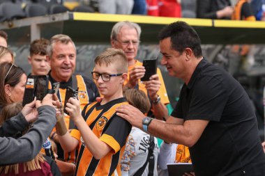 Hull City owner Acun Ilicali has a photo taken with a young fan before the Sky Bet Championship match Hull City vs Sheffield United at MKM Stadium, Hull, United Kingdom, 4th September 202