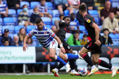 Shane Long #7 of Reading tackled by Tariqe Fosu #24 of Stoke City and Morgan Fox #3 of Stoke City during the Sky Bet Championship match Reading vs Stoke City at Select Car Leasing Stadium, Reading, United Kingdom, 4th September 202
