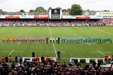 Oyuncular bir dakikalık saygı duruşunda sıralanırken, büyük ekranda İngiltere 'nin Gloucester Premiership maçı sırasında Gloucester vs Wasps' a karşı Kingsholm Stadyumu 'nda perşembe günü vefat eden Kraliçe II. Elizabeth' in görüntüsü görülüyor.