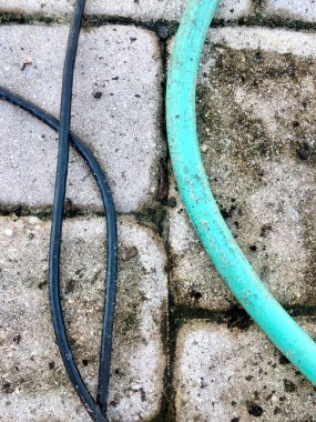 Döşeme taşlarındaki hortumlar ve kablolar