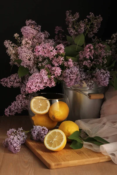 Lilac. Lemons. Still life with lilac and lemons. Low key. Imagen de archivo
