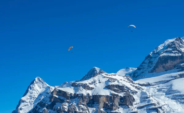 Paragliders voor de beroemde Zwitserse bergen Eiger, Moench en Jungfrau — Stockfoto