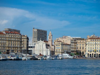 Marseille, France, is famous for its old harbour. View of the waterfront with historic buildings in front of Eglise Saint-Ferreol les Augustins when crossing the old harbour.