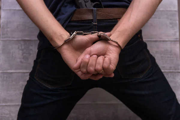 Man Handcuffs Holding Gun His Hands His Back — Stock Photo, Image