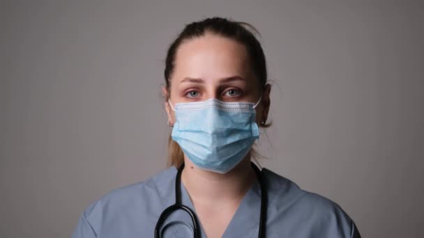 Female doctor coughs in a protective mask — Video Stock