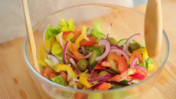 Руки кавказького чоловіка перемішують свіжий салат — стокове відео