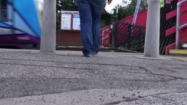 Pendler läuft am Bahnhof auf vorbeifahrenden Zug zu — Stockvideo