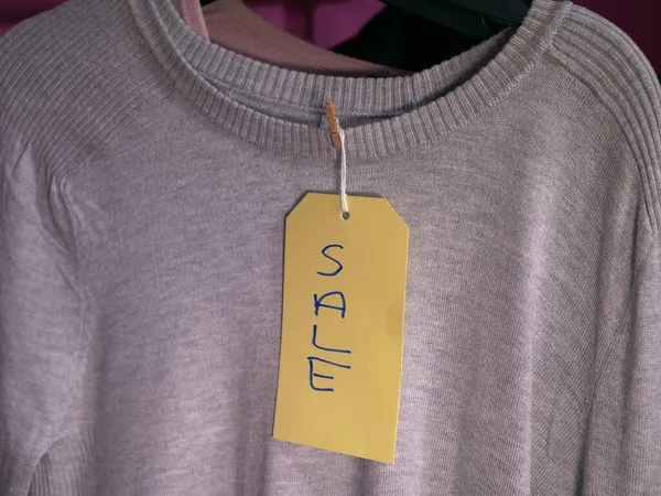 Elbise dükkanında bir kazakta indirim etiketi. — Stok fotoğraf