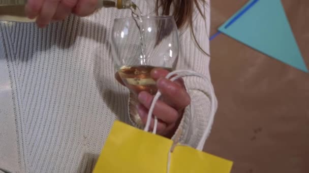 Birthday girl pours white wine holding gift — Stock Video