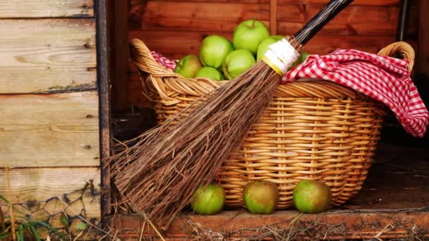 Basket of fresh baking apples with broomstick for Halloween — Stock Video