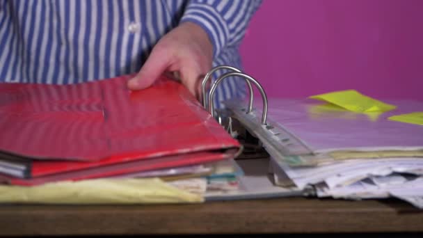 Busy person looking through files and folders of paperwork — Stock Video