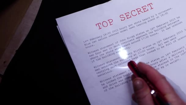 Reading top secret document torch — Stock Video