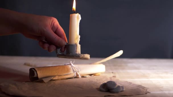 Lighting vintage style candle with parchment paper — Stockvideo