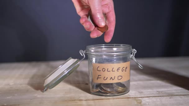 Dropping money in savings fund for college — Stockvideo