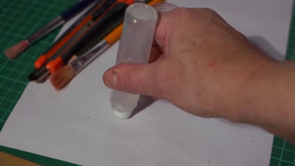 Hand using glue in an arts project — Stockvideo