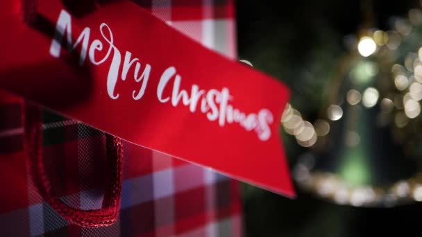 Wrapped Christmas gift with golden bokeh background — Αρχείο Βίντεο