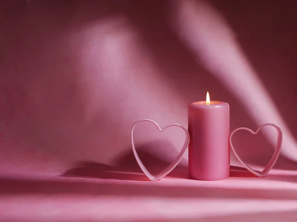 Románticos corazones de amor rosa y vela sobre fondo rosa —  Fotos de Stock