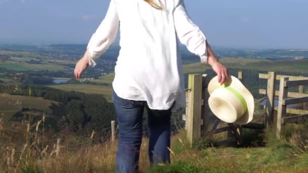 Woman walks through English National Park countryside — Stock Video