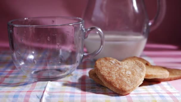 Ciasteczka w kształcie serca świeżo pieczone na różowym tle — Wideo stockowe