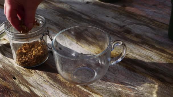 Making chamomile herbal tea on rustic background — Stock Video