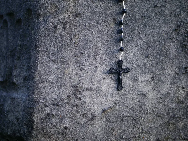 Rosário contas crucifixo pendura parede de pedra velha — Fotografia de Stock