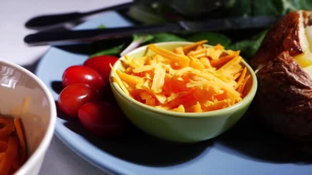 Baked jacket potato with butter with cheese sides — Stock Video