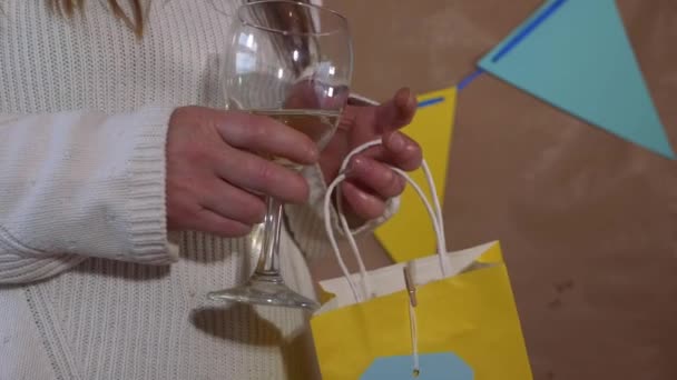 Birthday girl celebrating with white wine and gift — Stock Video