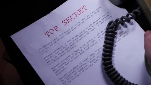 Making a phone call about top secret information in dark room — Stock Video