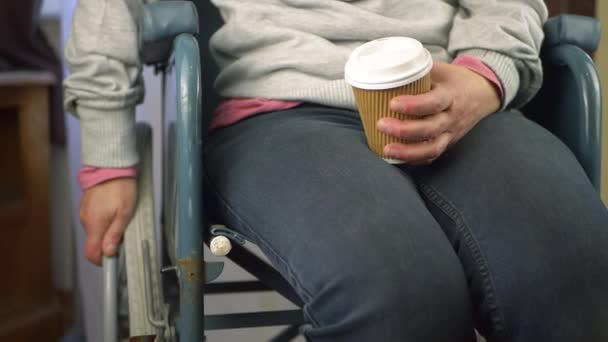 Utilisateur en fauteuil roulant avec café à emporter — Video