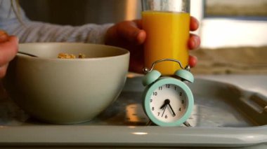 Eating breakfast with orange juice early morning zoom slow motion shot selective focus