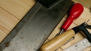 Carpenter tools for woodwork on wooden background overhead panning zoom shot close up selective focus