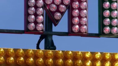 Fairground ride lights flashing at fun fair medium zoom slow motion shot selective focus