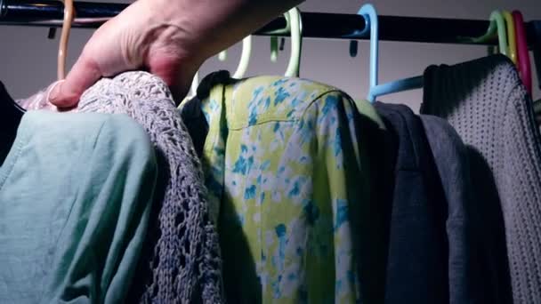 Looking Outfit Clothes Hung Rail Medium Shot Slow Motion Selective — Vídeo de Stock