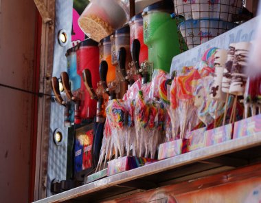 Food stall with candy at fun fair medium shot selective focus