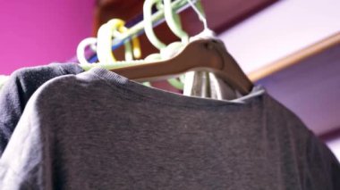 Clothes hung on a rail medium 4k shot slow motion selective focus