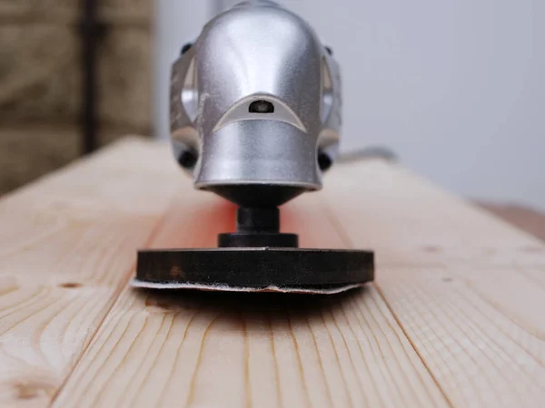 Multi tool with sanding disc medium shot on wood background medium selective focus