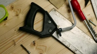 Carpenter tools for woodwork on wooden background overhead panning zoom shot medium selective focus