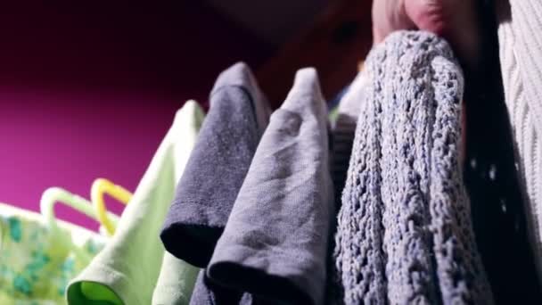 Looking Outfit Clothes Hung Rail Medium Low Shot Slow Motion — Vídeo de Stock