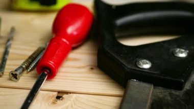 Carpenter tools for woodwork on wooden background close up panning zoom shot medium selective focus