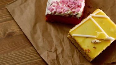 Selection of decorated homemade cakes medium overhead flat lay panning zoom shot selective focus