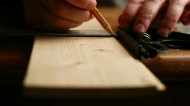 Carpenter using square to measure on wooden background medium 4k shot selective focus