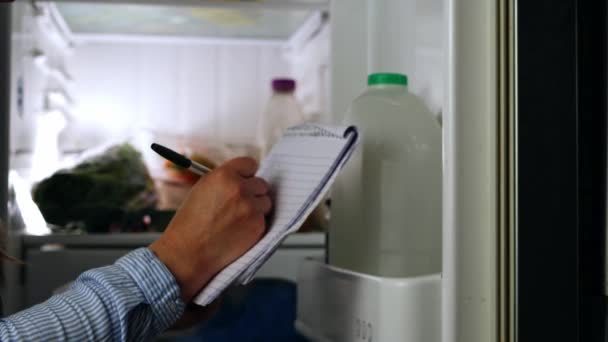 Looking Refrigerator Making Shopping List Shot Selective Focus — Video Stock