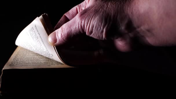 Hand Opening Pages Old Bible Dark Background Medium Shot Selective — Stock videók