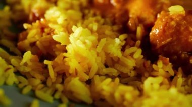 Chicken Korma curry with Pilau rice overhead close up zoom shot slow motion selective focus