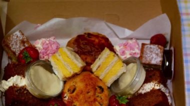 Selection of cakes and sweets for afternoon tea medium zoom flat lay selective focus