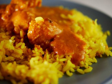 Chicken Korma curry with Pilau rice close up shot selective focus